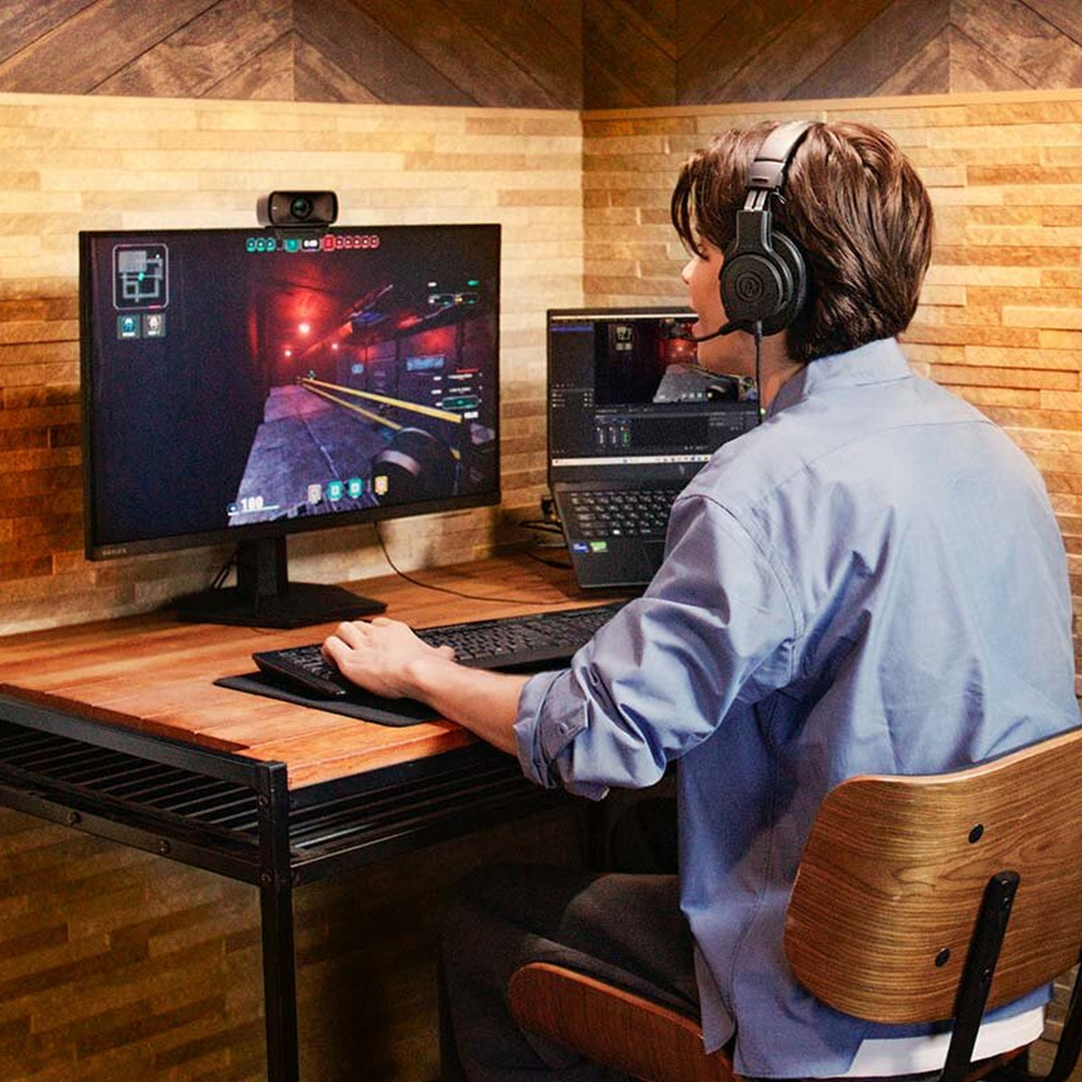 Gamer wearing the Audio-Technica ATH-M20xSTS at a dual-screen desk