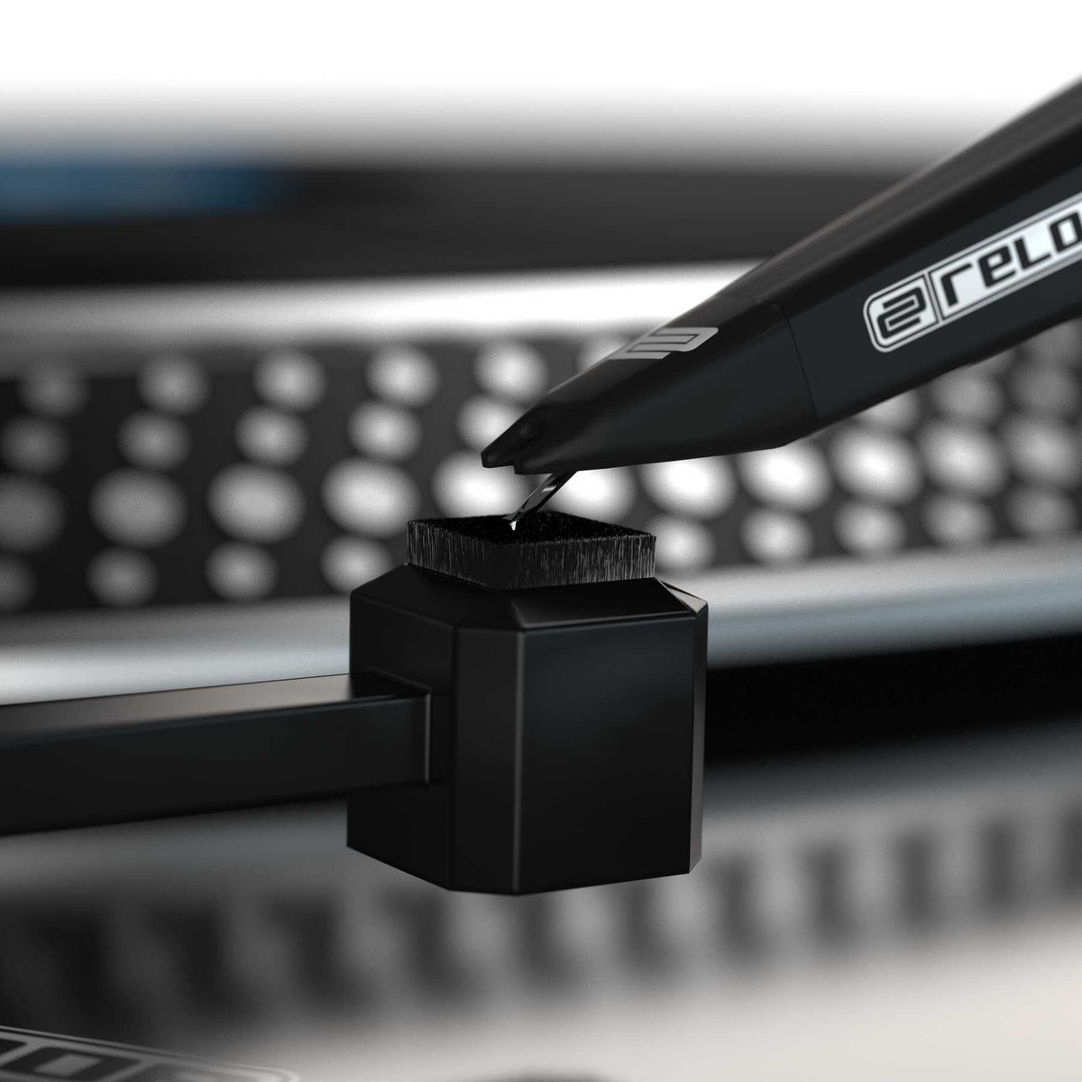 Reloop Premium Stylus Brush for record cleaning, featuring soft bristles to safely remove dust from turntable stylus.