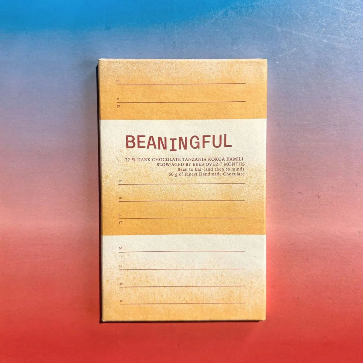 Beaningful Tanzania 72% dark chocolate bar with beehive label, showcasing the packaging and rich chocolate texture in close-up.